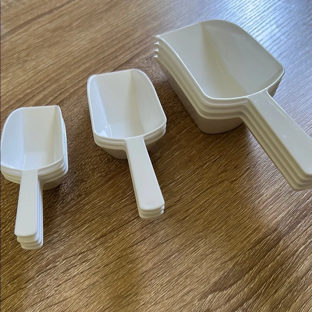 Stack of White Plastic Scoops - 11 pieces